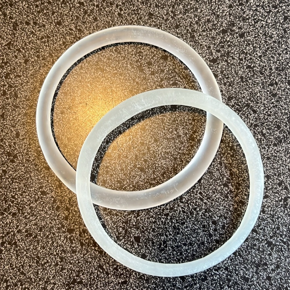 Glass bangle bracelets upcycled from beverage bottles. by artist Kathleen Plate.